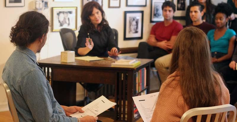This is an image form the summer acting program and the meisner intensive at the maggie flanigan studio. Karen chamberlain is talking to students while they are reading a script