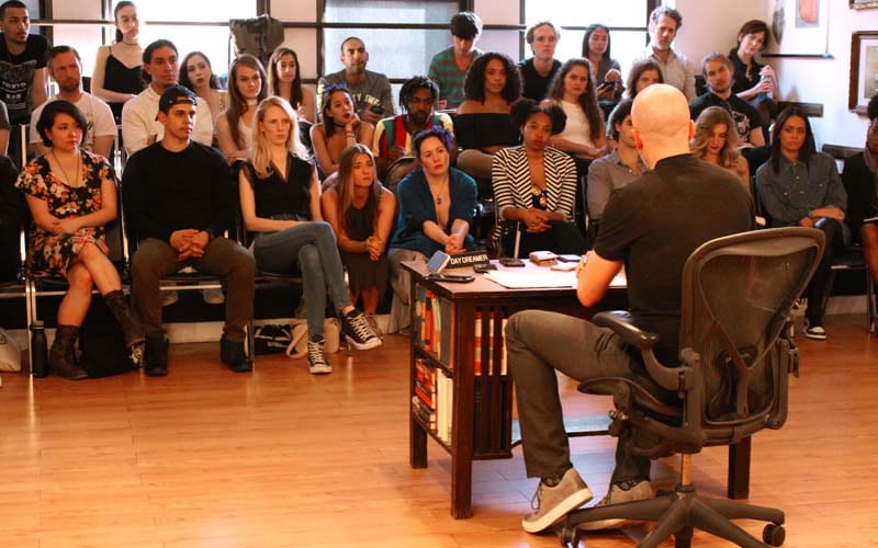 this image is from the maggie flanigan studio acting program. students are in class at the studio as part of the acting program for serious actors. Students are with charlie Sandlan who is addressing the students at the end of the first year of the two year program. 