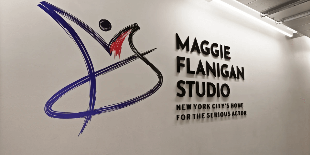 Maggie Flanigan logo and sign on a white wall