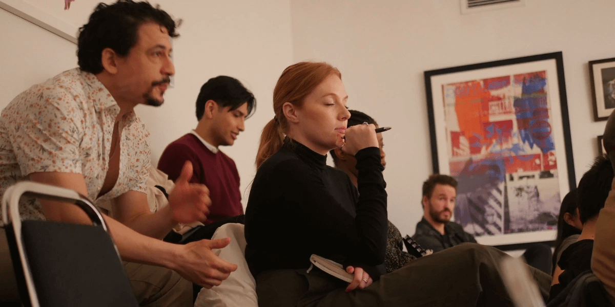 Students enrolled in the Meisner acting program, listening and taking notes