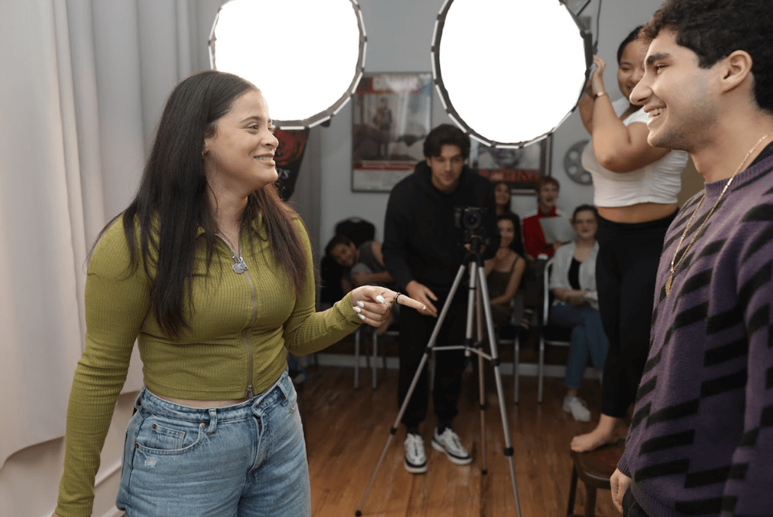 Two actors acting in front of a camera.